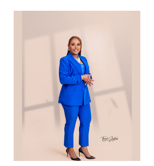 Professional Black woman scientist in a blue suit standing confidently, representing the Blueprint Lab and AI strategy leadership for global professionals.